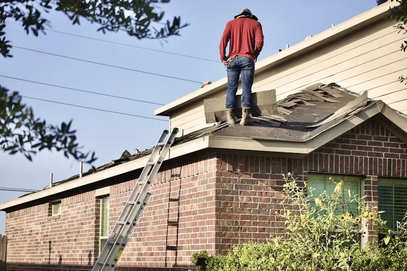 Professional roofer working on a residential roof in Carlinville